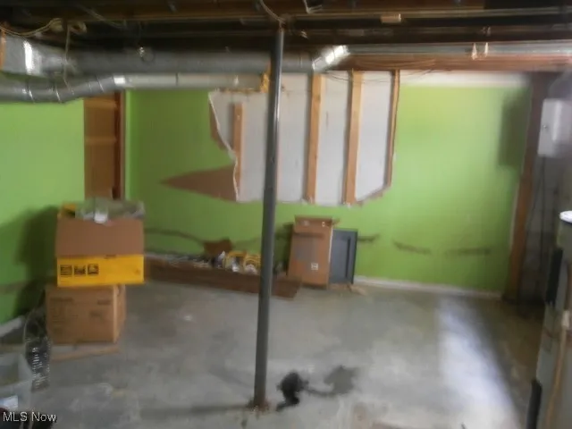 Unfinished basement featuring baseboards