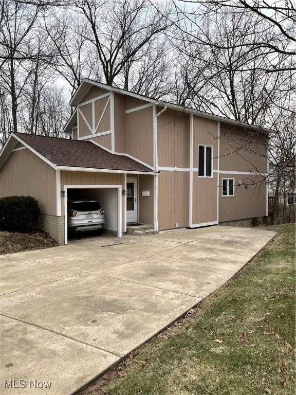 View of side of property with a garage and driveway