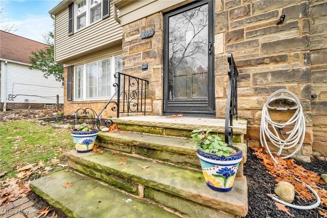 Entrance to property featuring stone siding