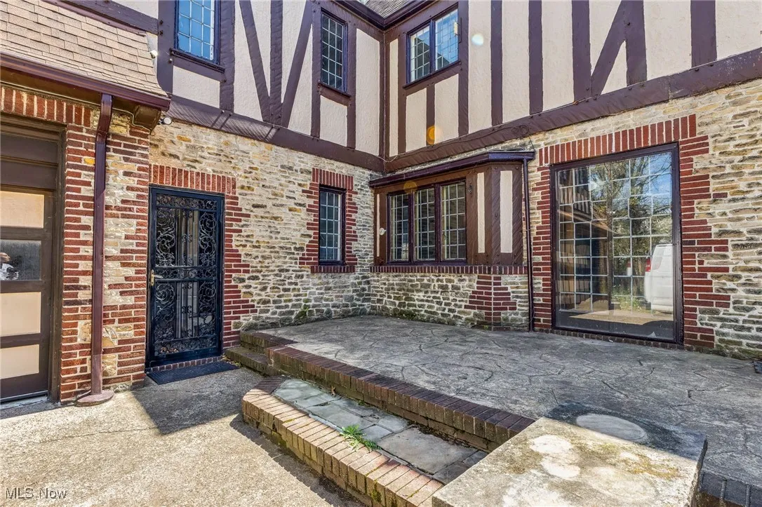 View of exterior entry with brick siding