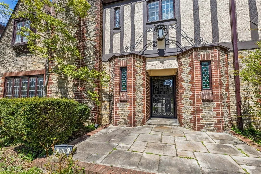 View of exterior entry with brick siding