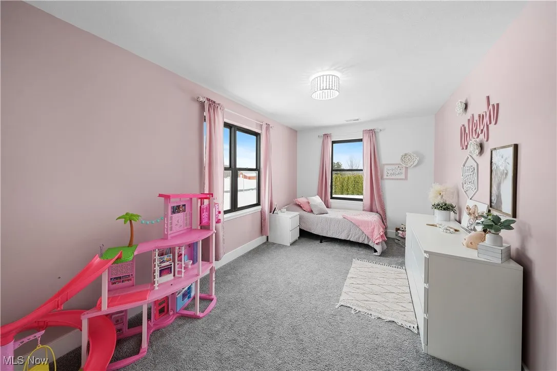 Bedroom with baseboards and carpet flooring