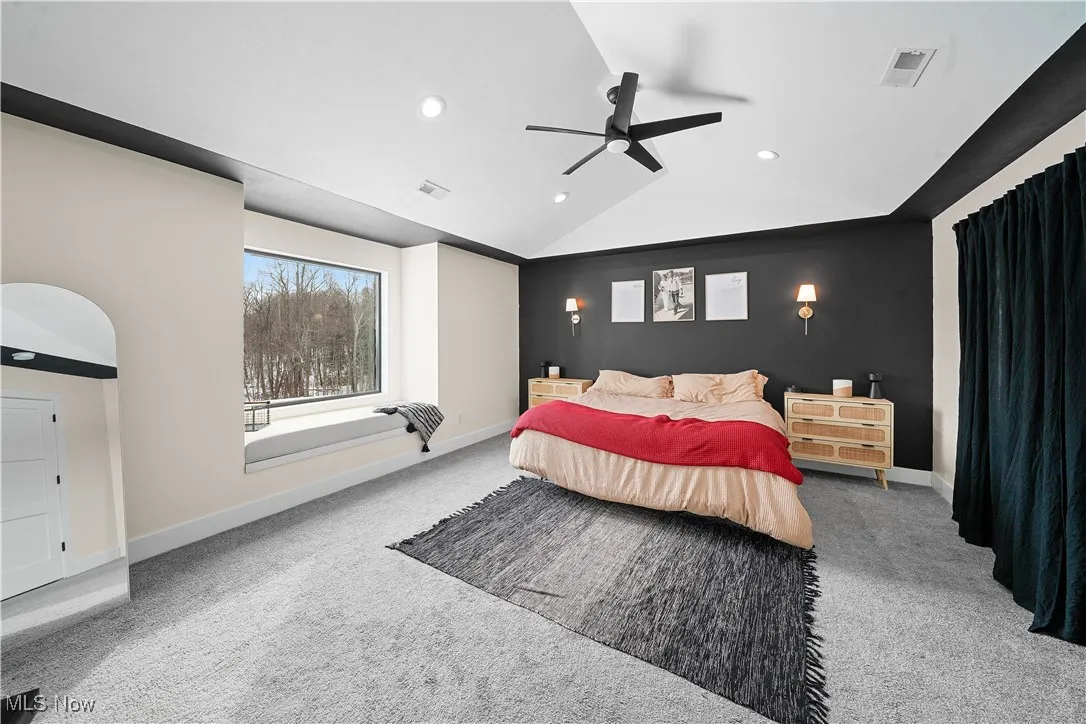 Carpeted bedroom featuring vaulted ceiling, a ceiling fan, baseboards, visible vents, and recessed lighting