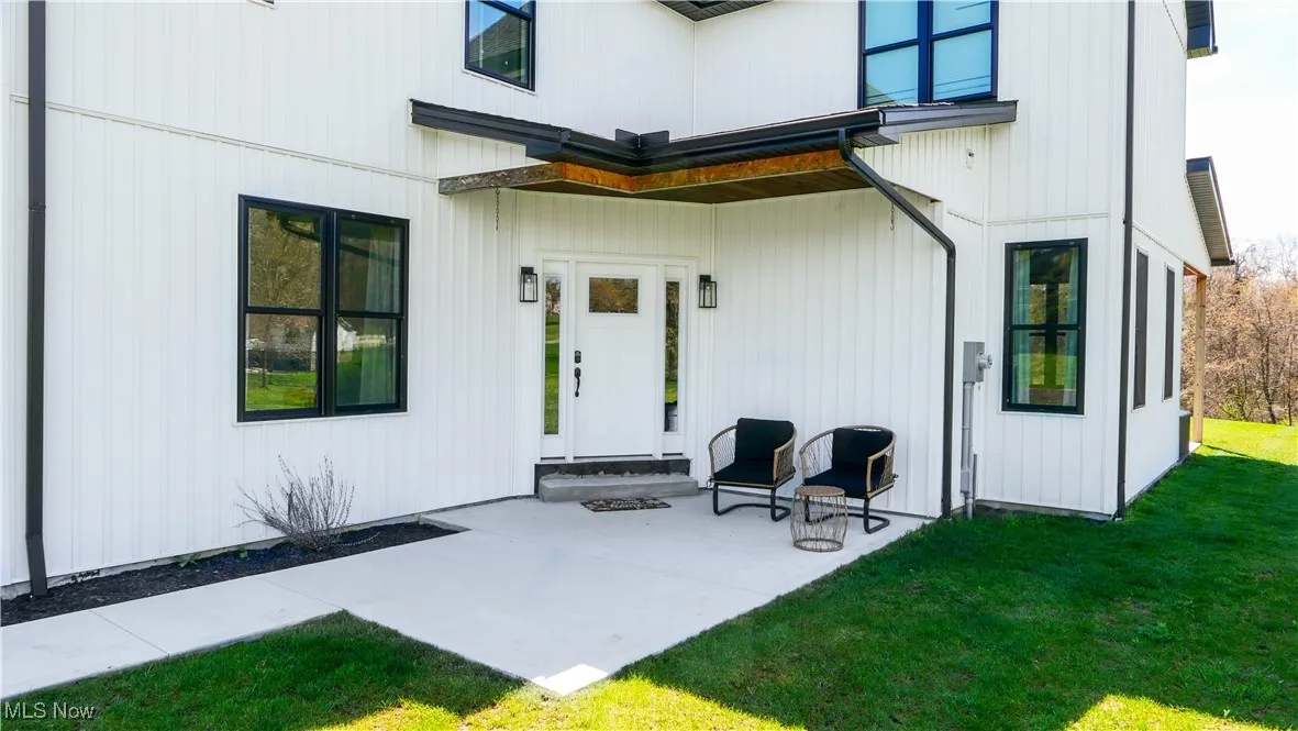 Doorway to property with a patio area and a yard
