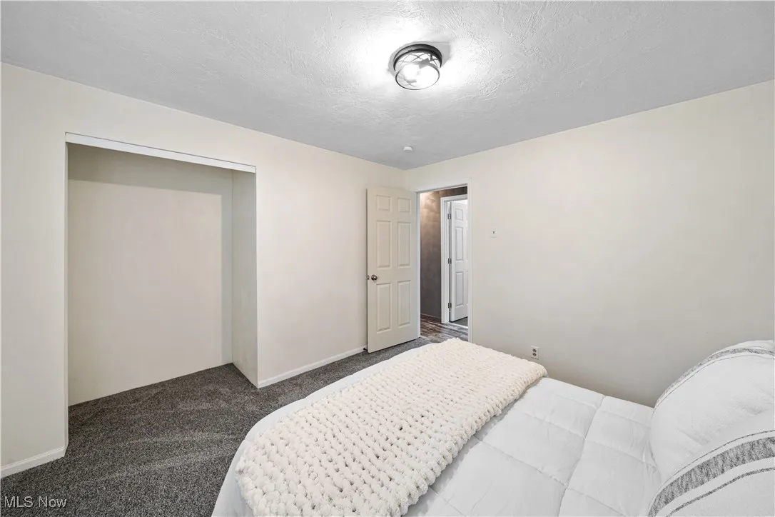 Carpeted bedroom featuring a textured ceiling