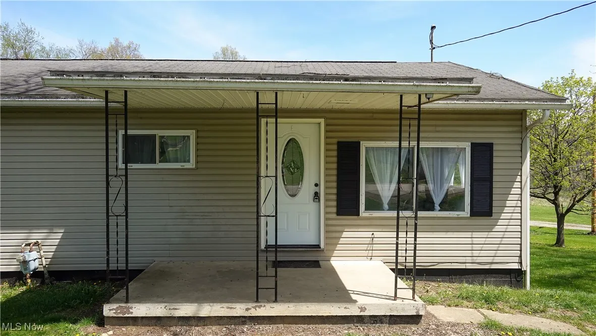 View of front of home with a shingled roof