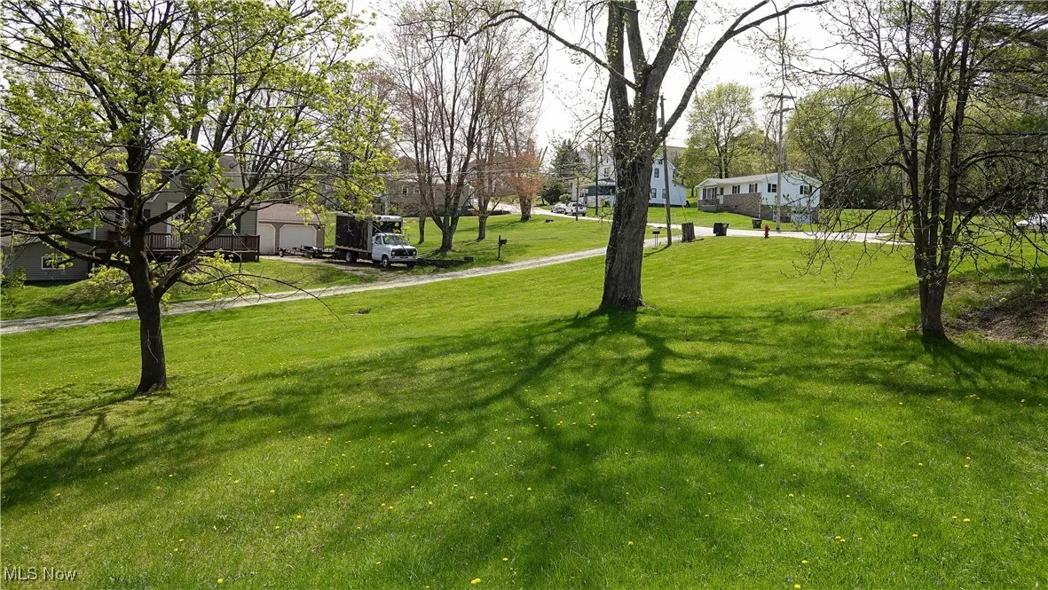 View of yard with a residential view and a garage