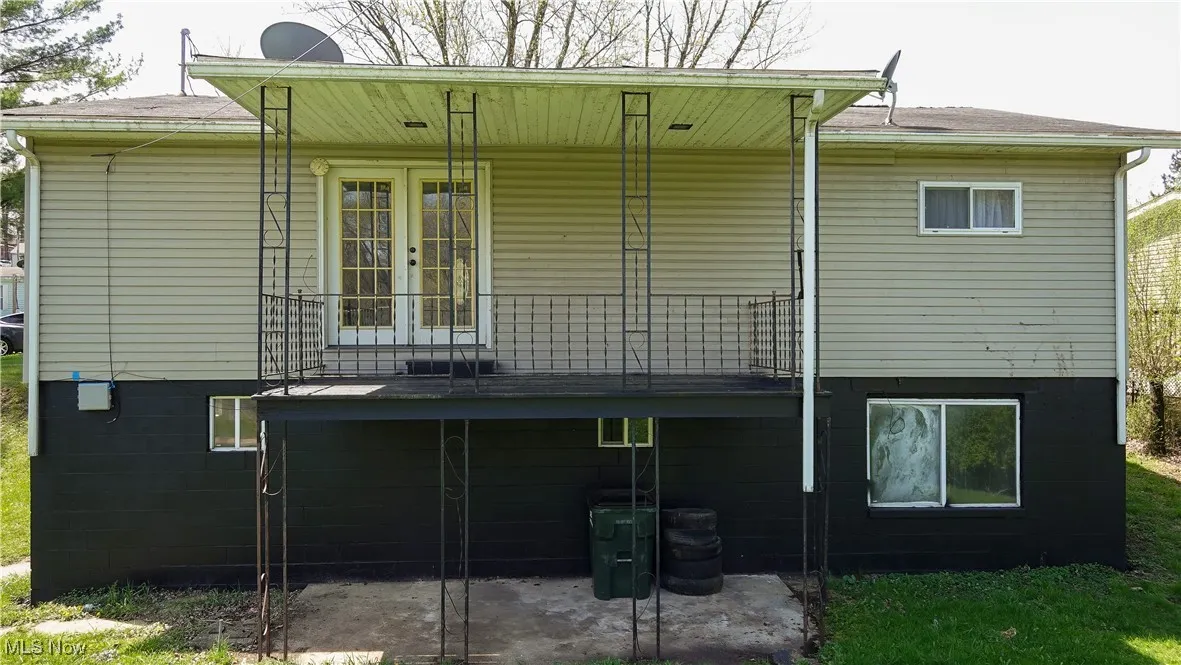 Rear view of property featuring a patio and french doors