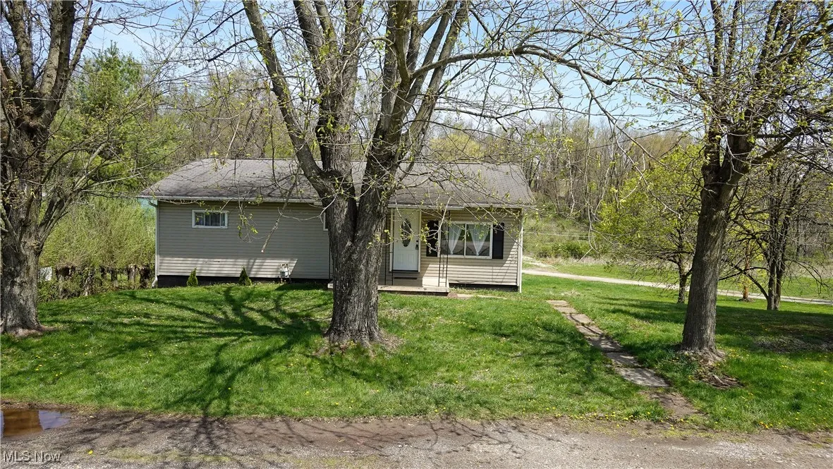 View of front facade featuring a front lawn and a porch