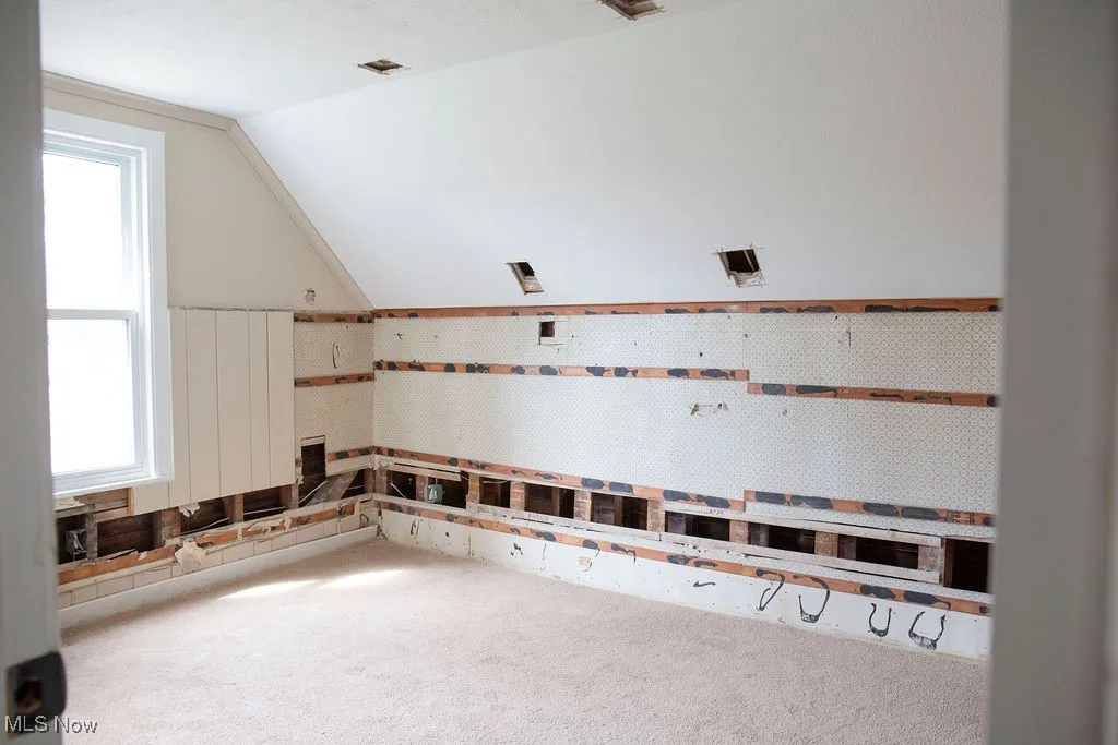 Unfurnished bedroom with baseboards, a closet, and light colored carpet