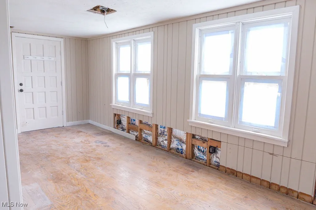 Spare room featuring baseboards and wood finished floors