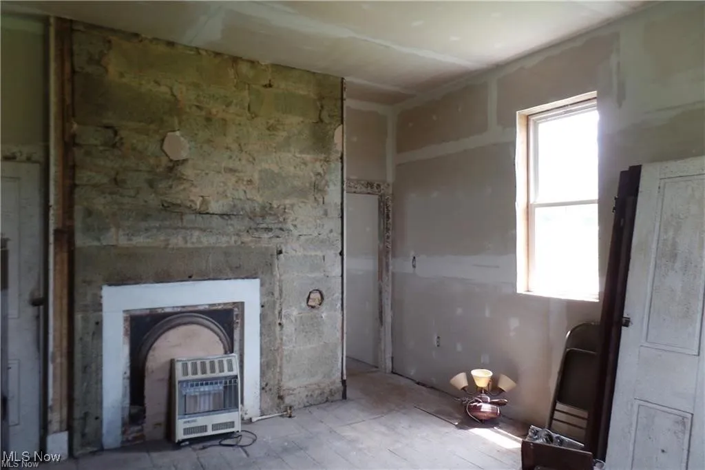 Unfurnished living room with heating unit