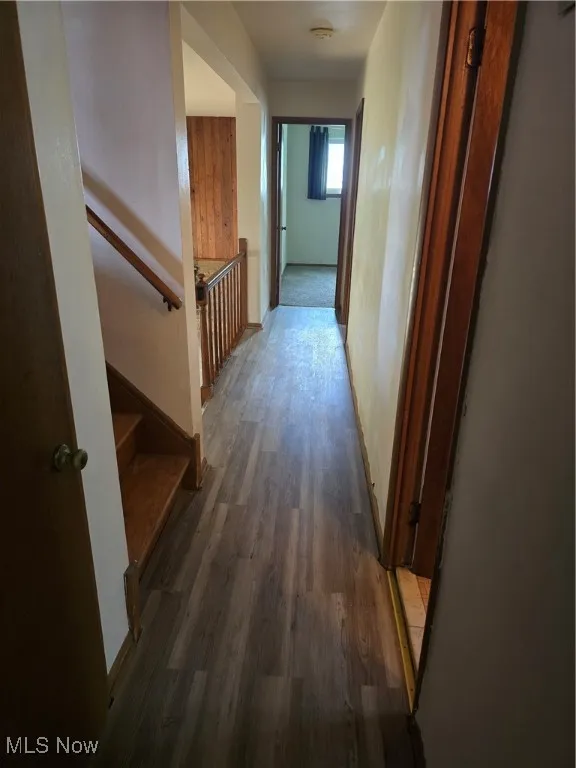 Hall with wood finished floors and baseboards