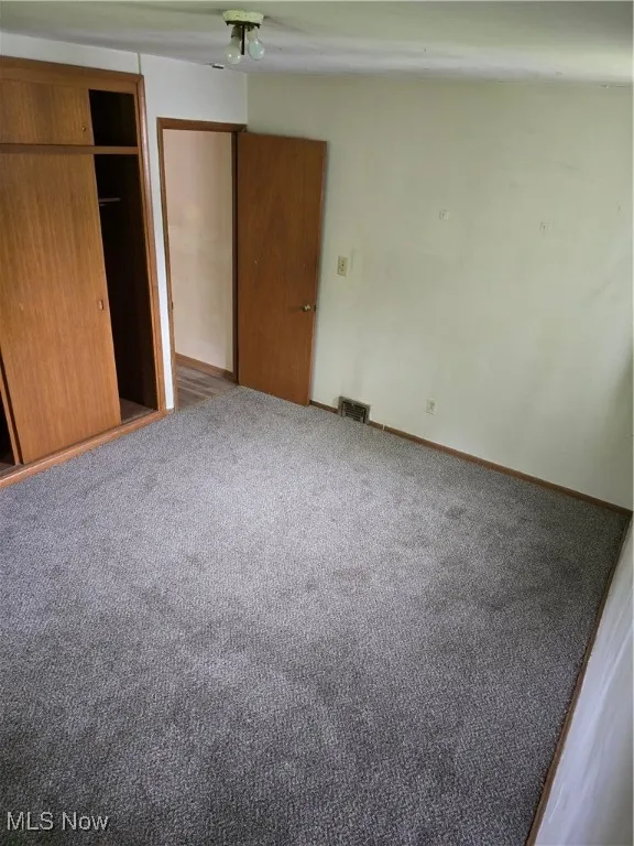 Unfurnished bedroom with carpet flooring