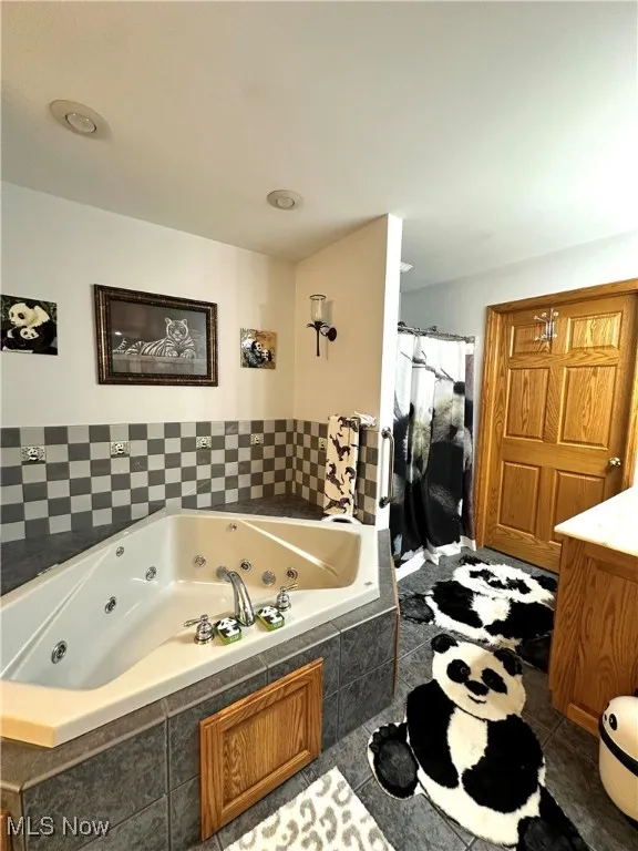 Bathroom with a jetted tub and vanity