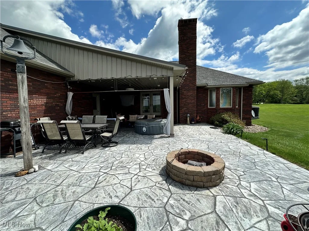 View of patio / terrace featuring an outdoor fire pit