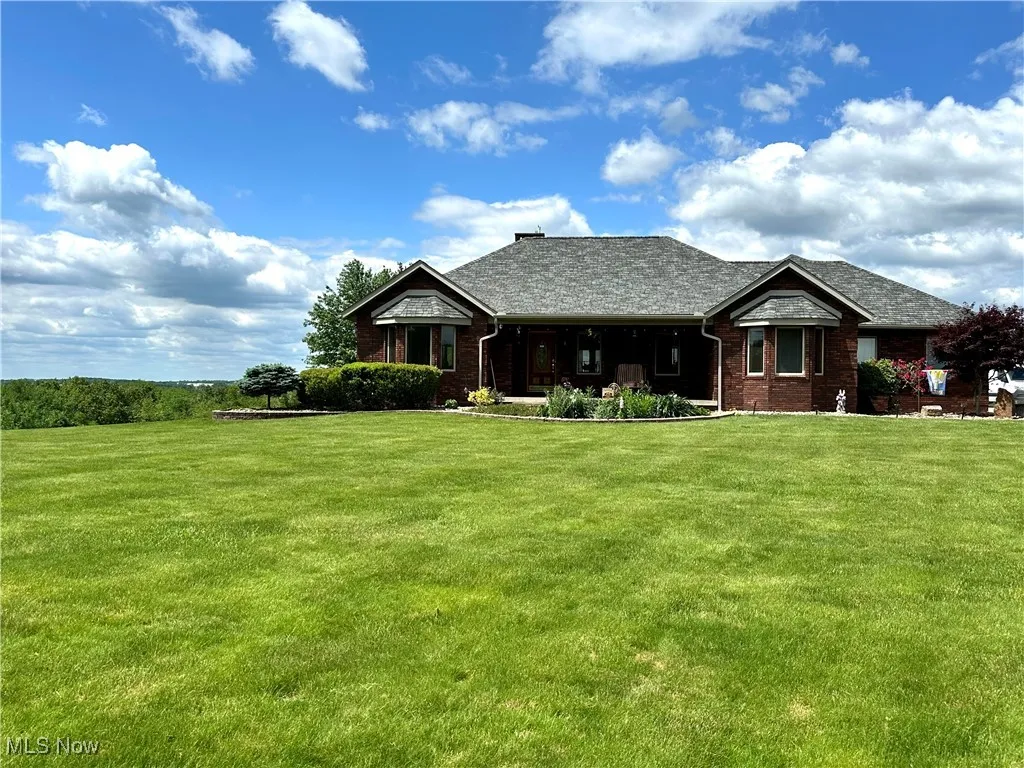 View of front of home with a front lawn and brick siding