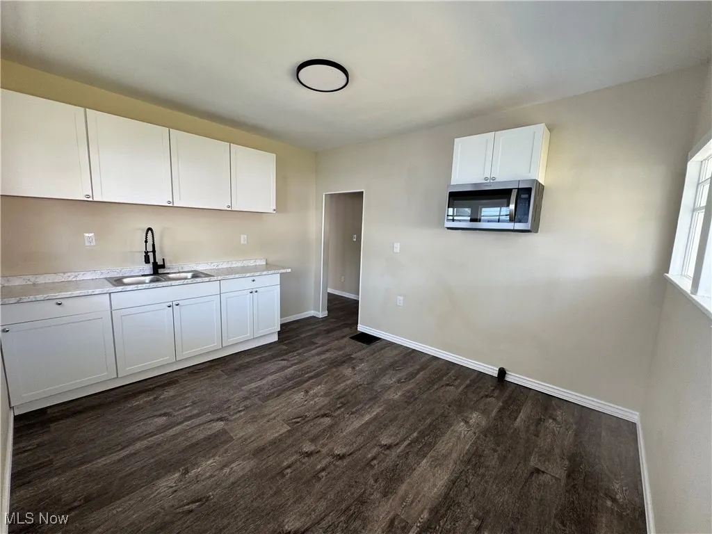 Kitchen with new cabinetry and stainless steel microwave