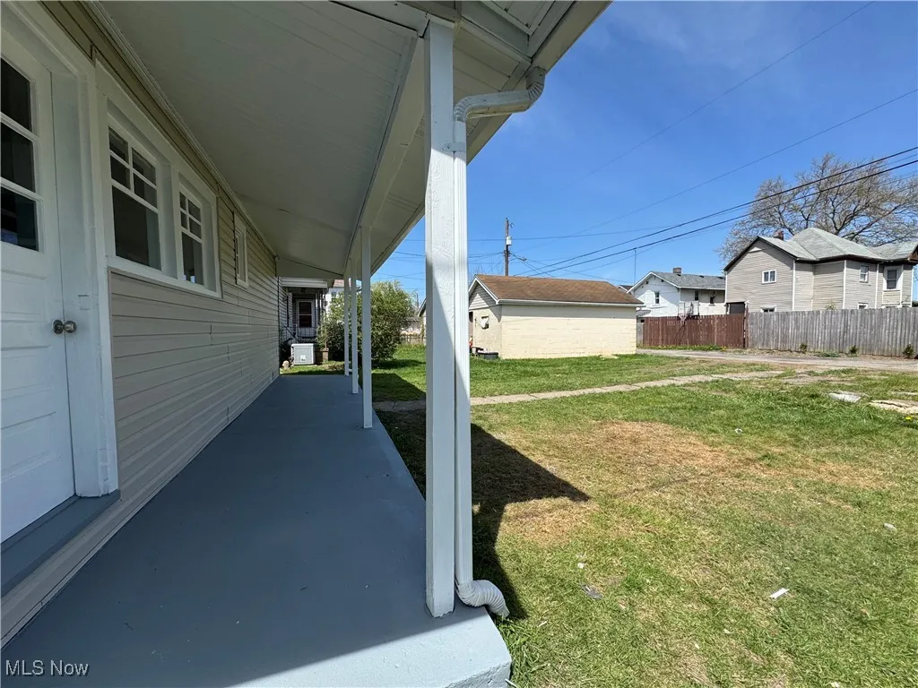 view of back covered porch and yard