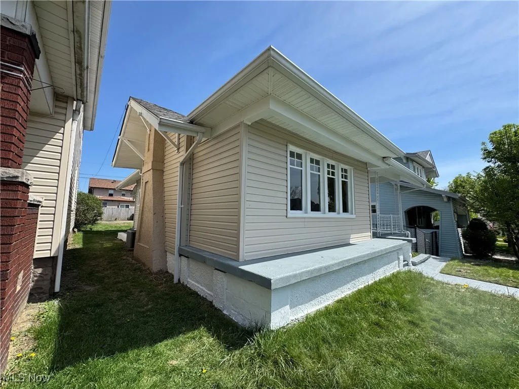 View of side of home featuring a yard