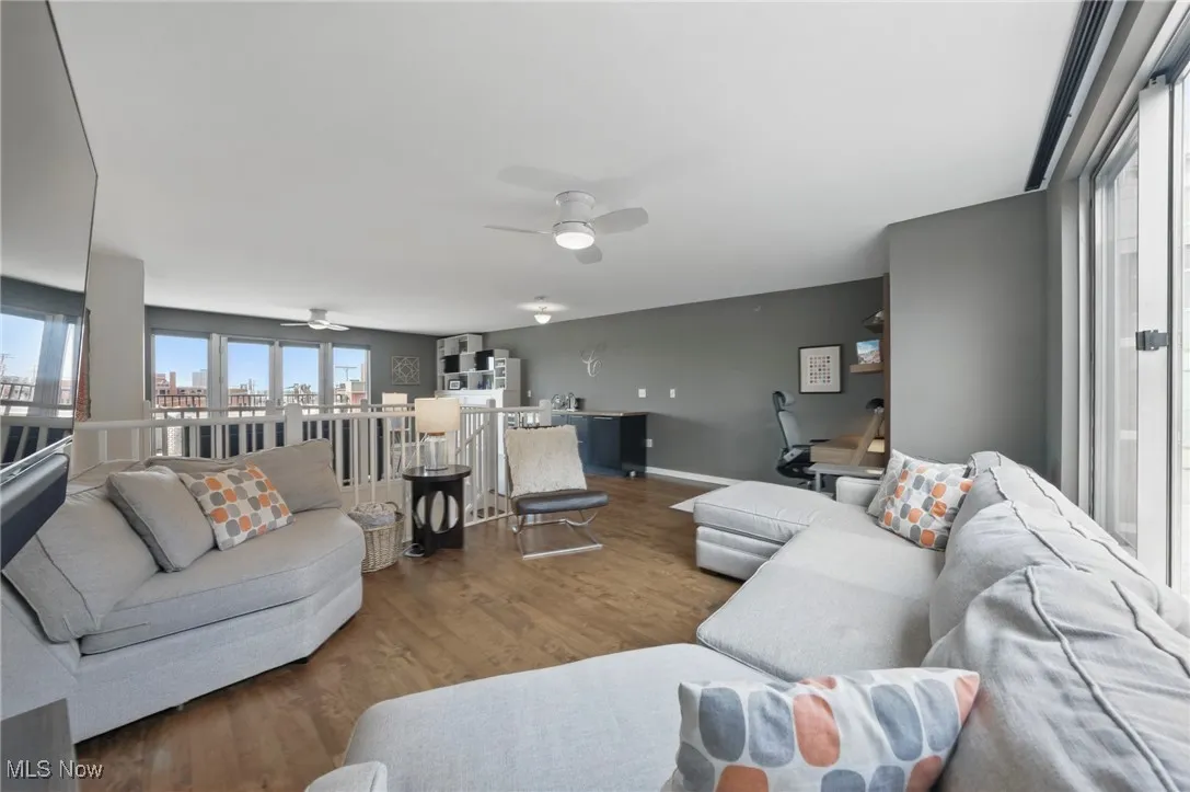 Living area featuring wood finished floors and a ceiling fan