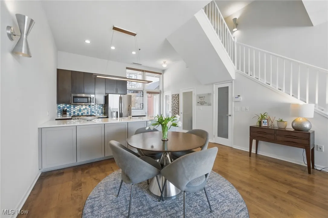Dining area with baseboards, recessed lighting, stairway, and dark wood-style flooring