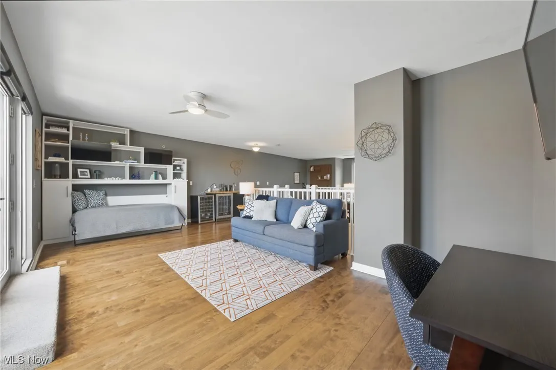 Living room featuring ceiling fan and wood finished floors