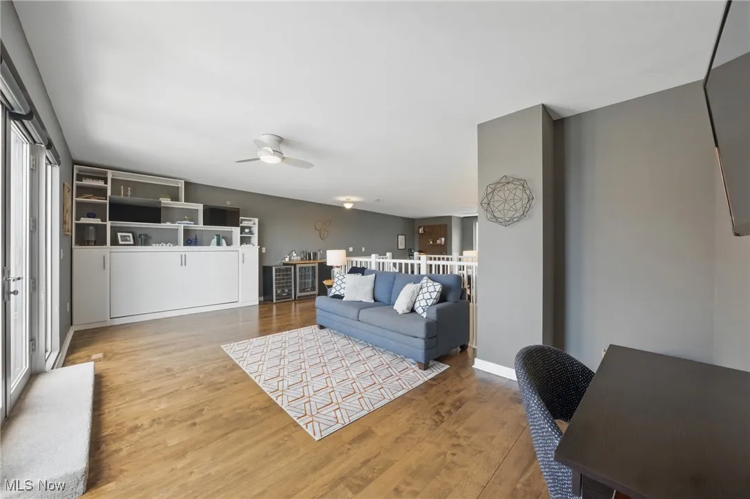 Living area featuring a ceiling fan and wood finished floors