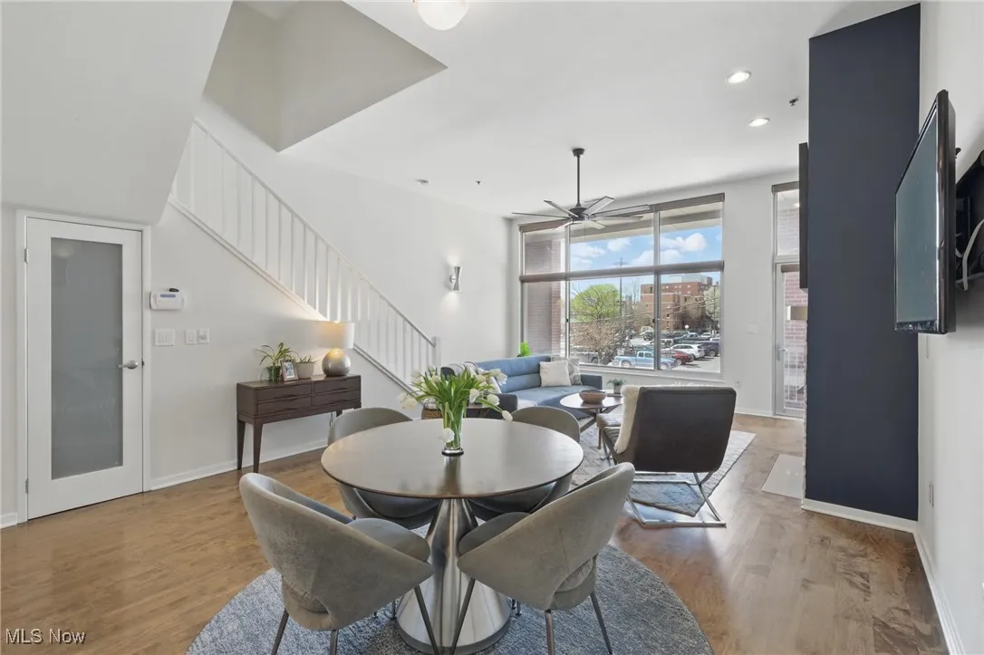 Dining area with ceiling fan, light wood-style flooring, recessed lighting, and stairway