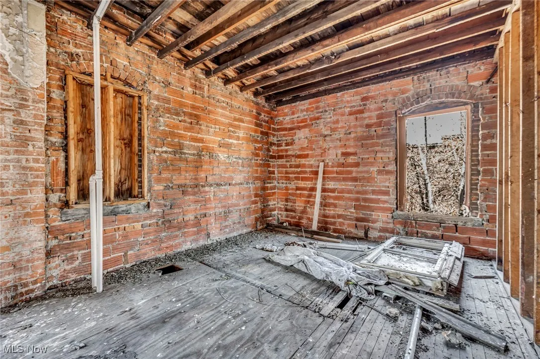 Miscellaneous room with brick wall