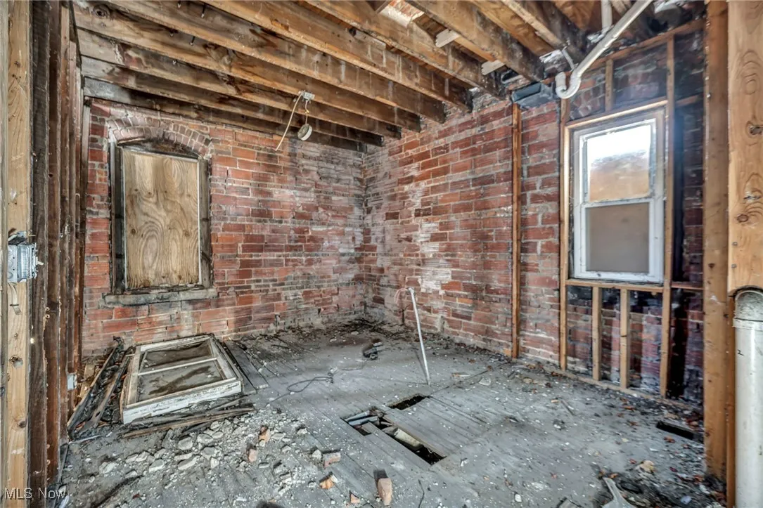 Miscellaneous room featuring brick wall