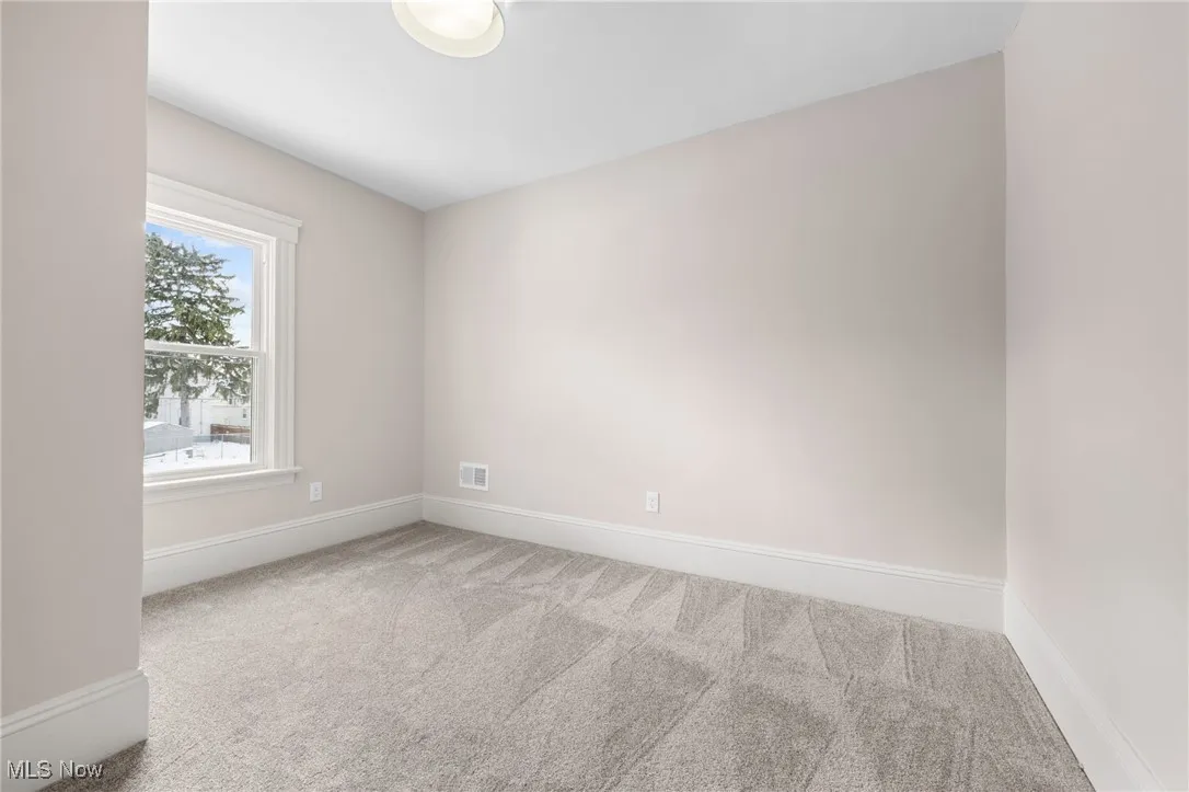 Carpeted bedroom with baseboards