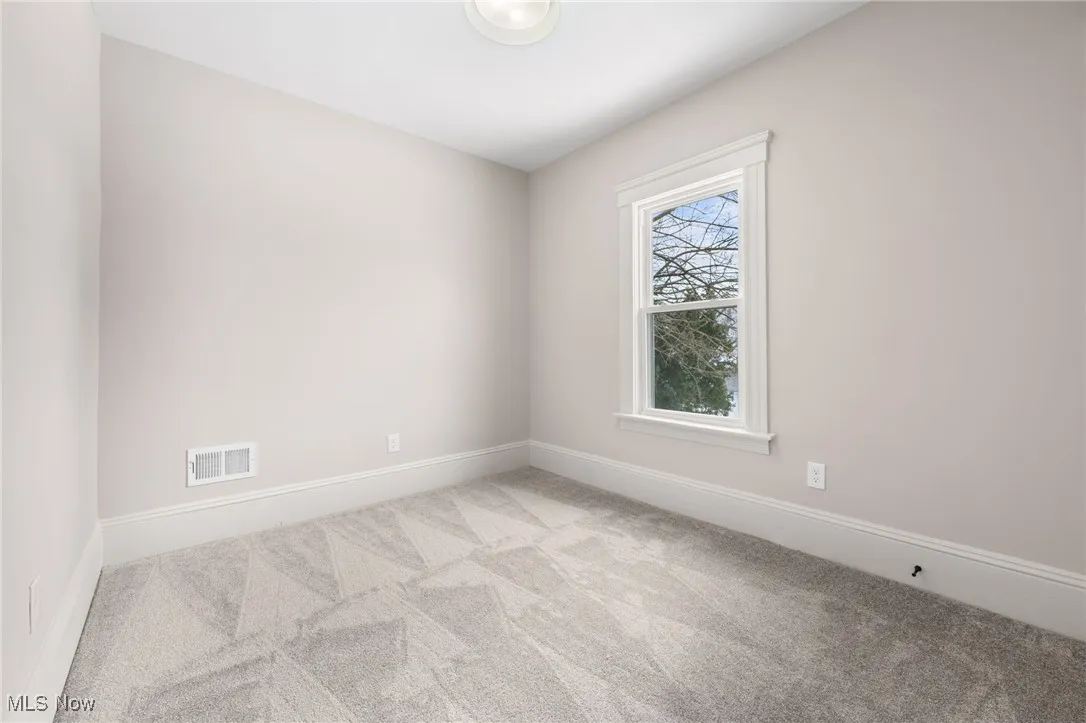 Carpeted bedroom with baseboards