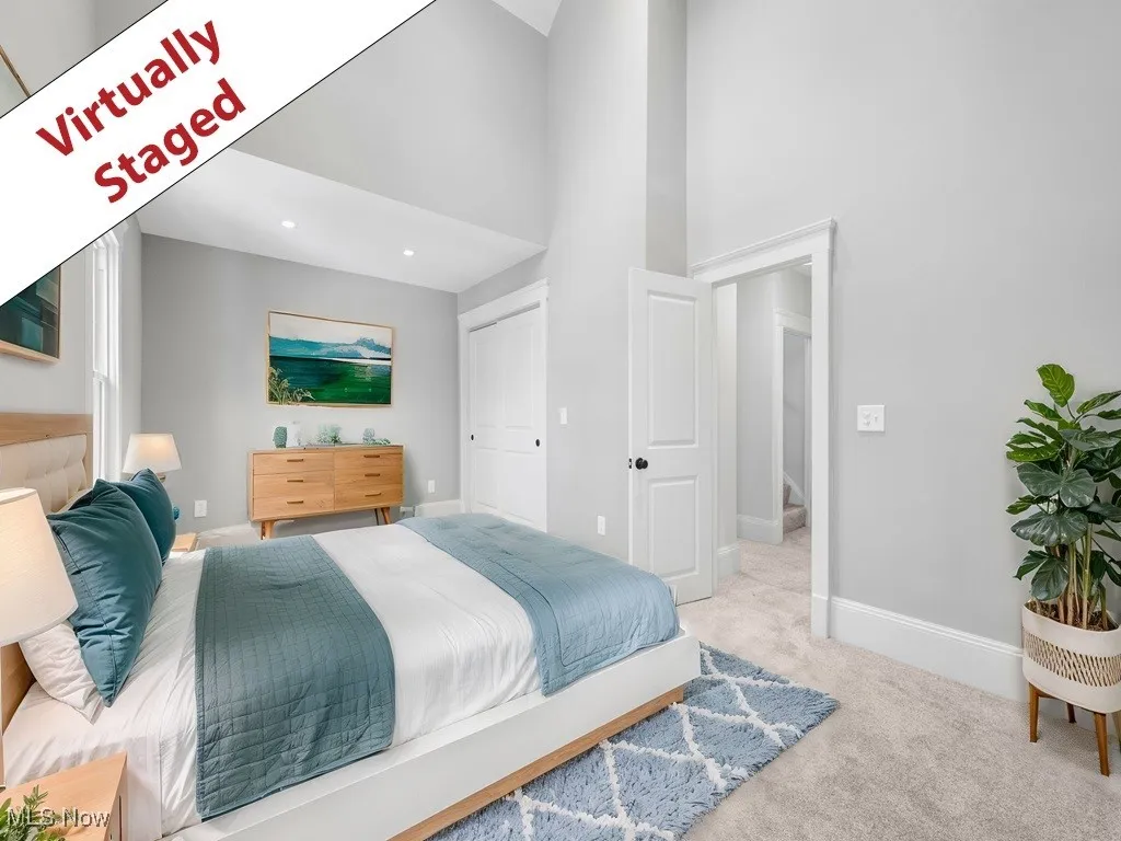 Carpeted bedroom featuring recessed lighting, a towering ceiling, and baseboards