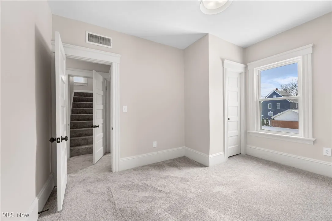 Unfurnished bedroom with baseboards, and carpet