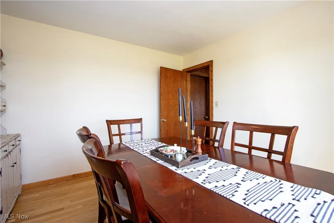 Dining space with light wood finished floors and baseboards