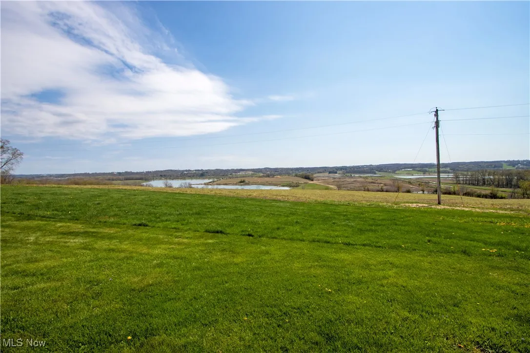 View of yard featuring a rural view and a water view