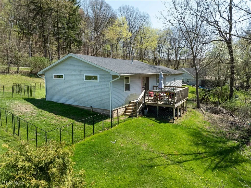 View of back of newer home with deck area