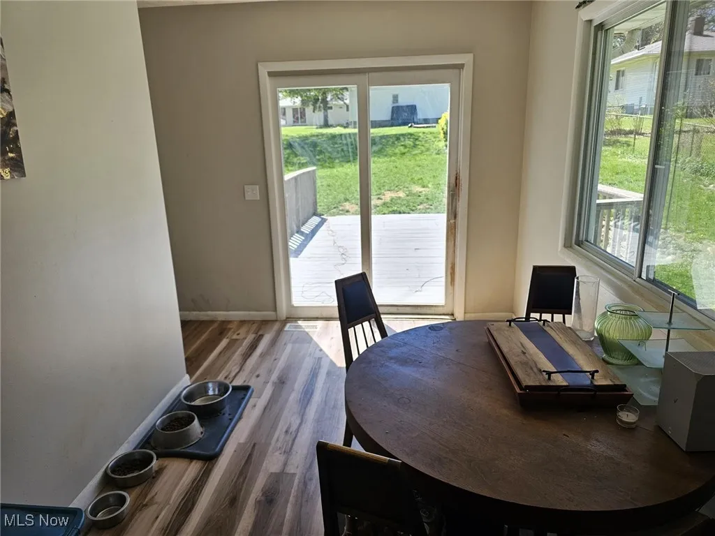 Dining area featuring baseboards and wood finished floors