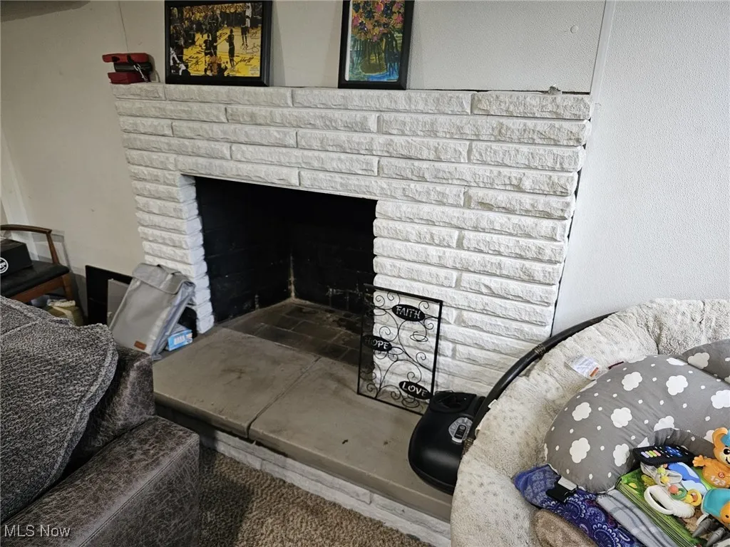 Interior details featuring a brick fireplace