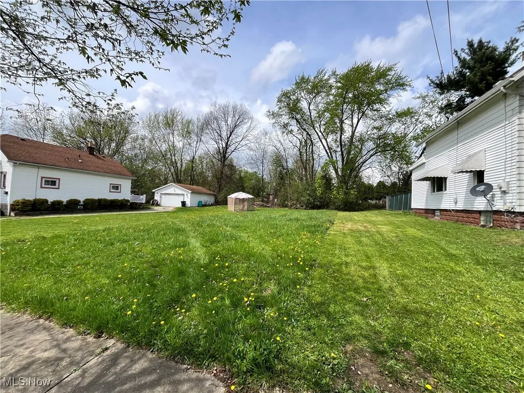 View of yard featuring an outbuilding and a detached garage