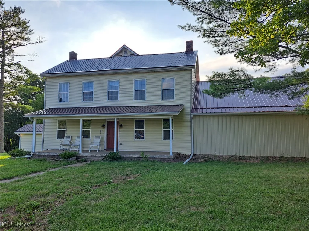 View of front of house with a front yard and covered porch