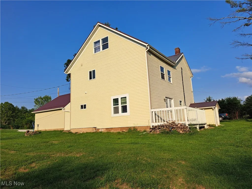 Back of house featuring a yard
