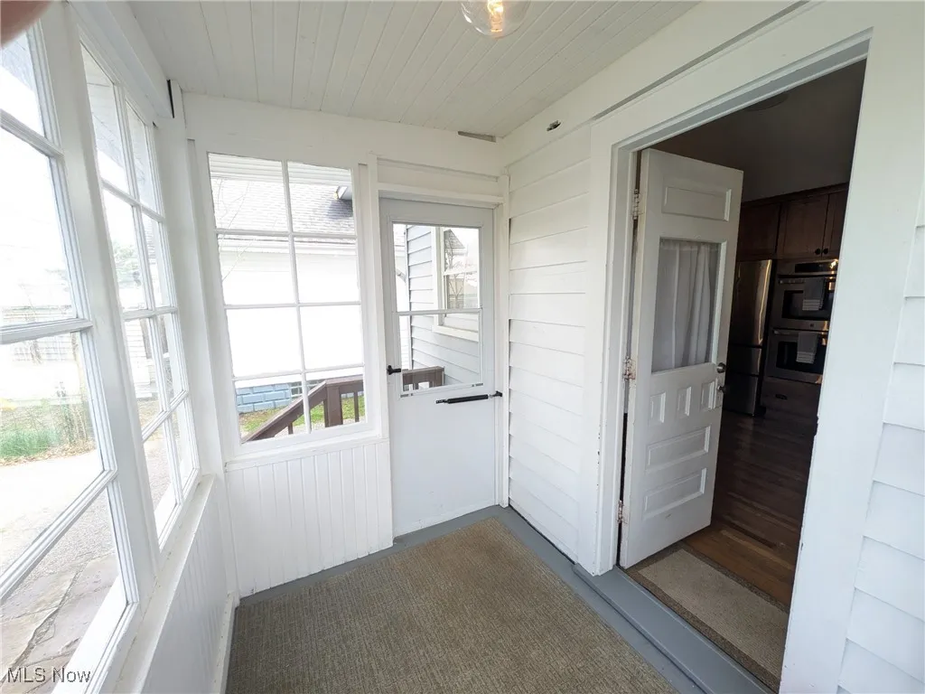 Small enclosed sun room off rear door entry