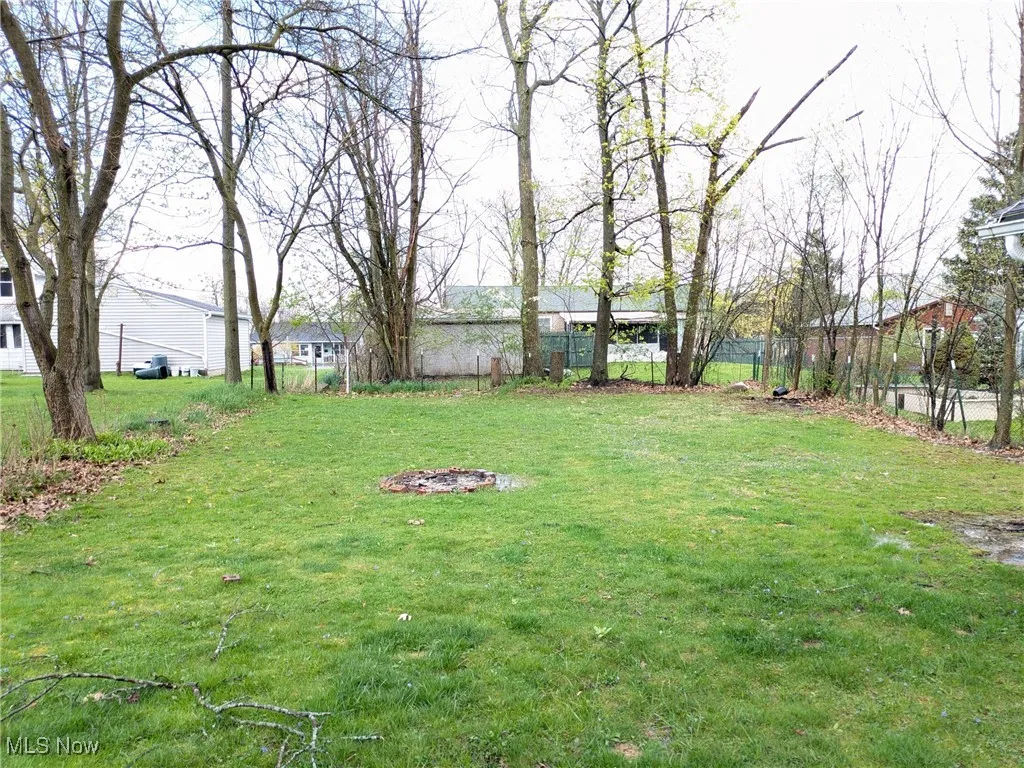 View from sun room, large back yard with firepit