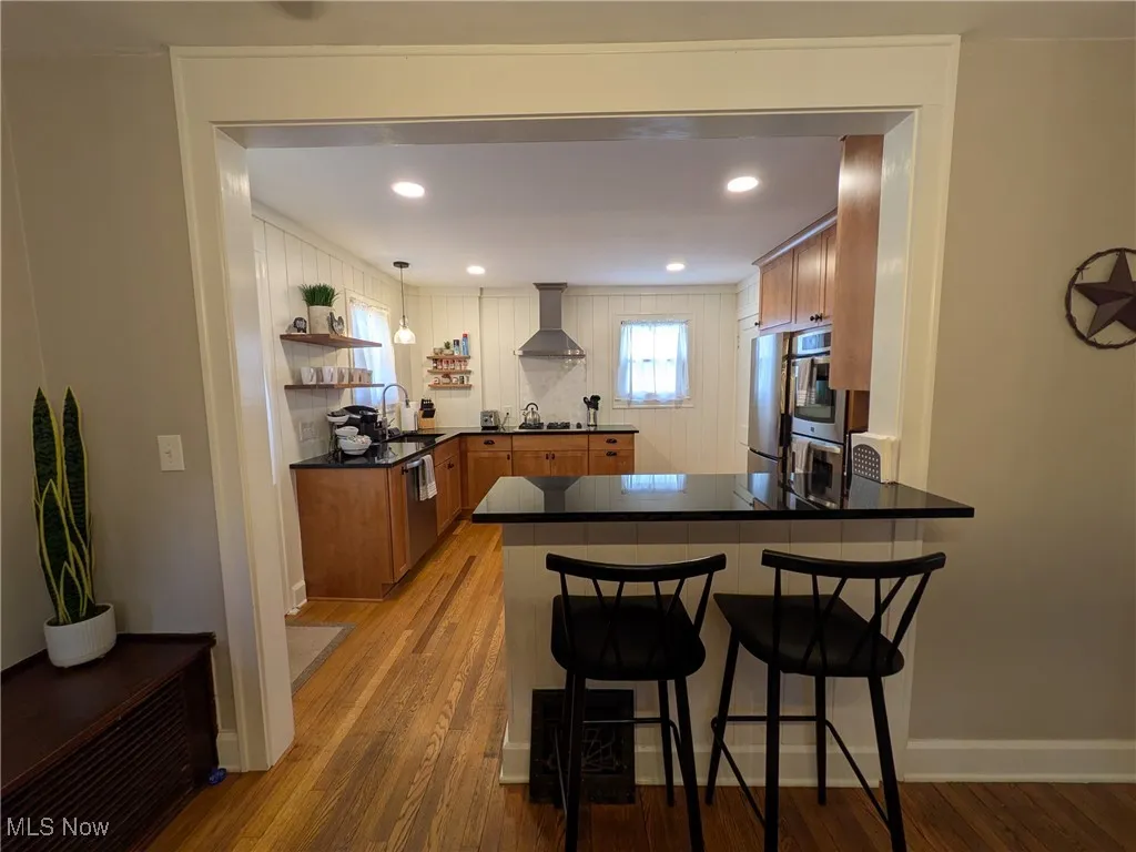 Dining area open to kitchen, separated by large granite breakfast bar