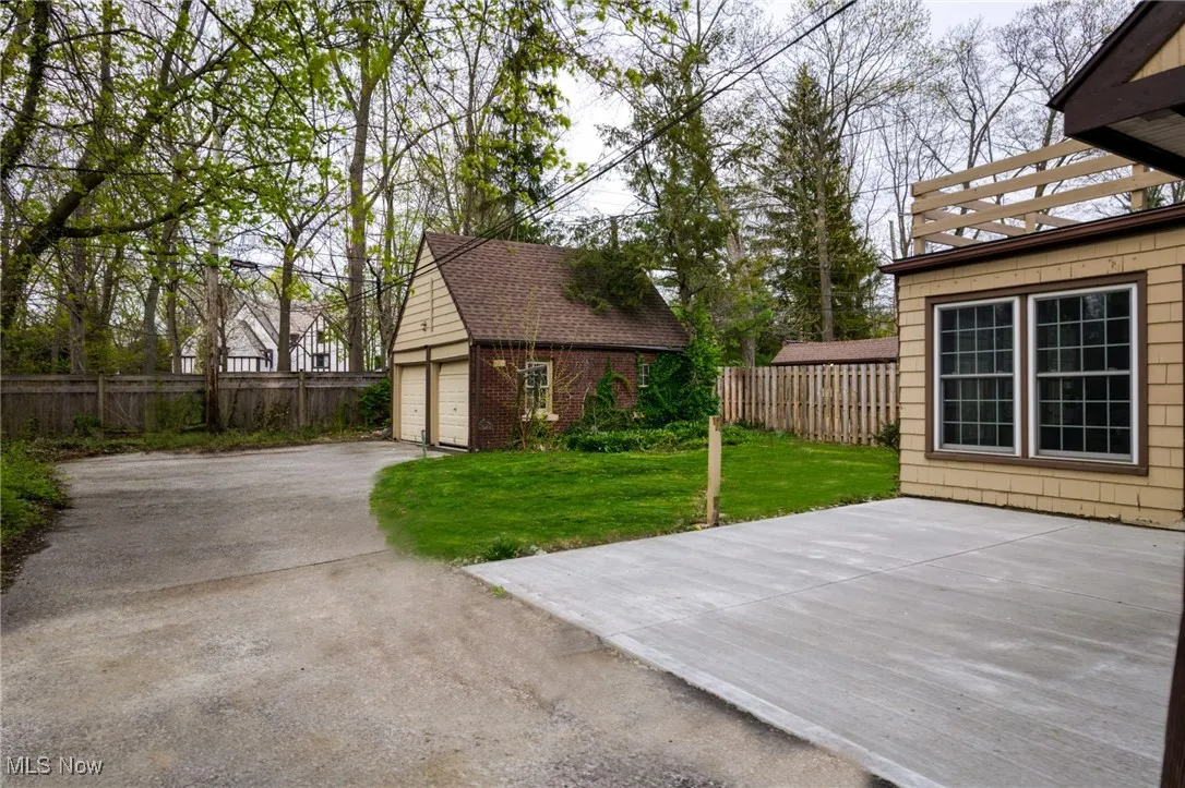 View of yard with a garage and an outdoor structure