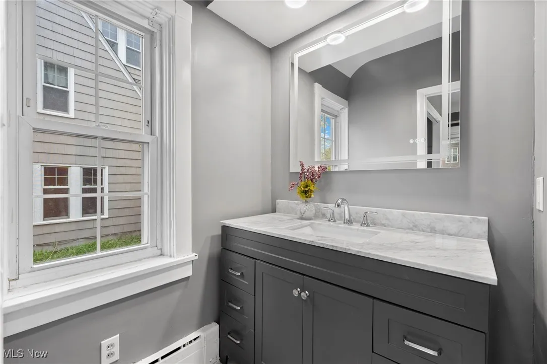 Bathroom featuring vanity and a baseboard heating unit