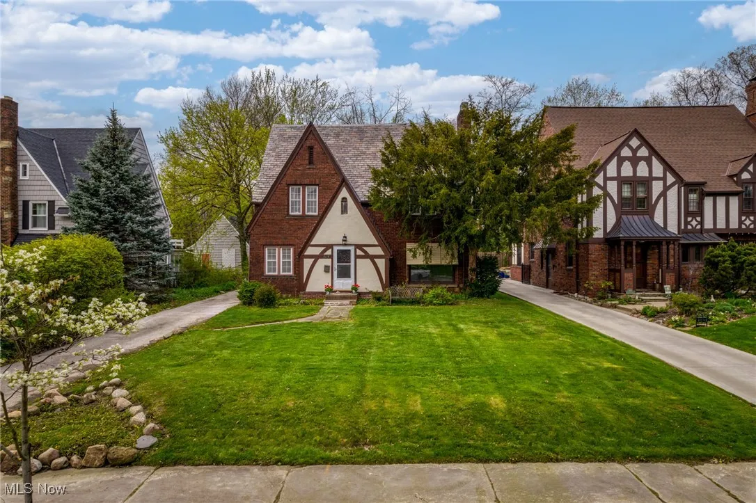 Tudor home with a front yard