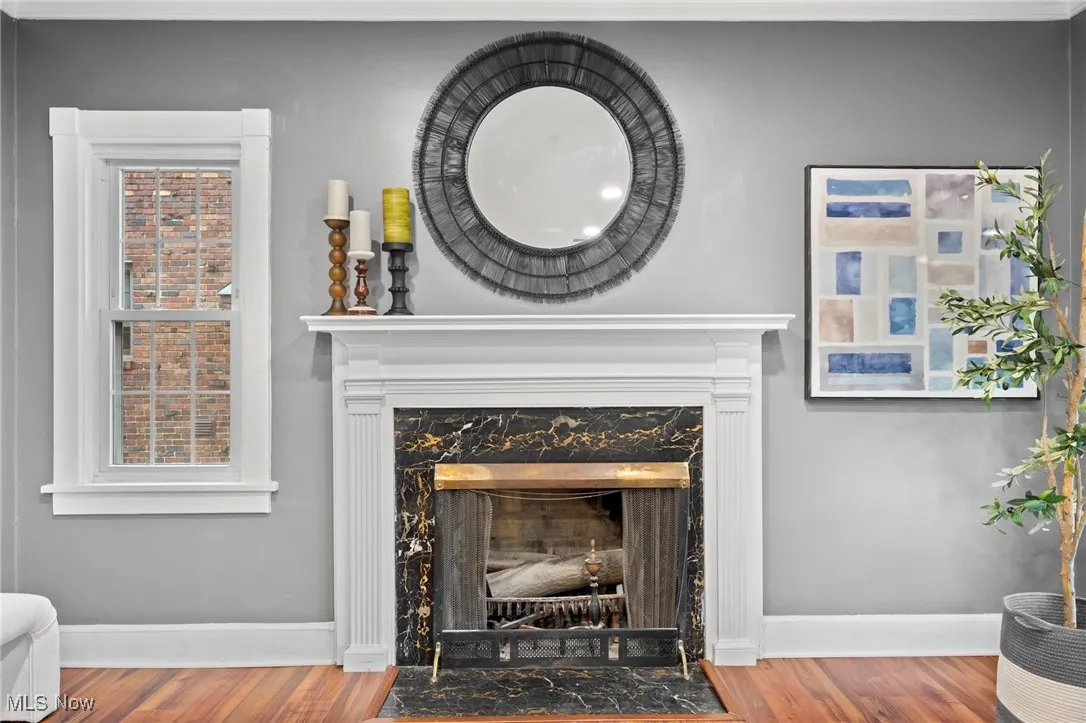 Room details with a premium fireplace and hardwood / wood-style floors